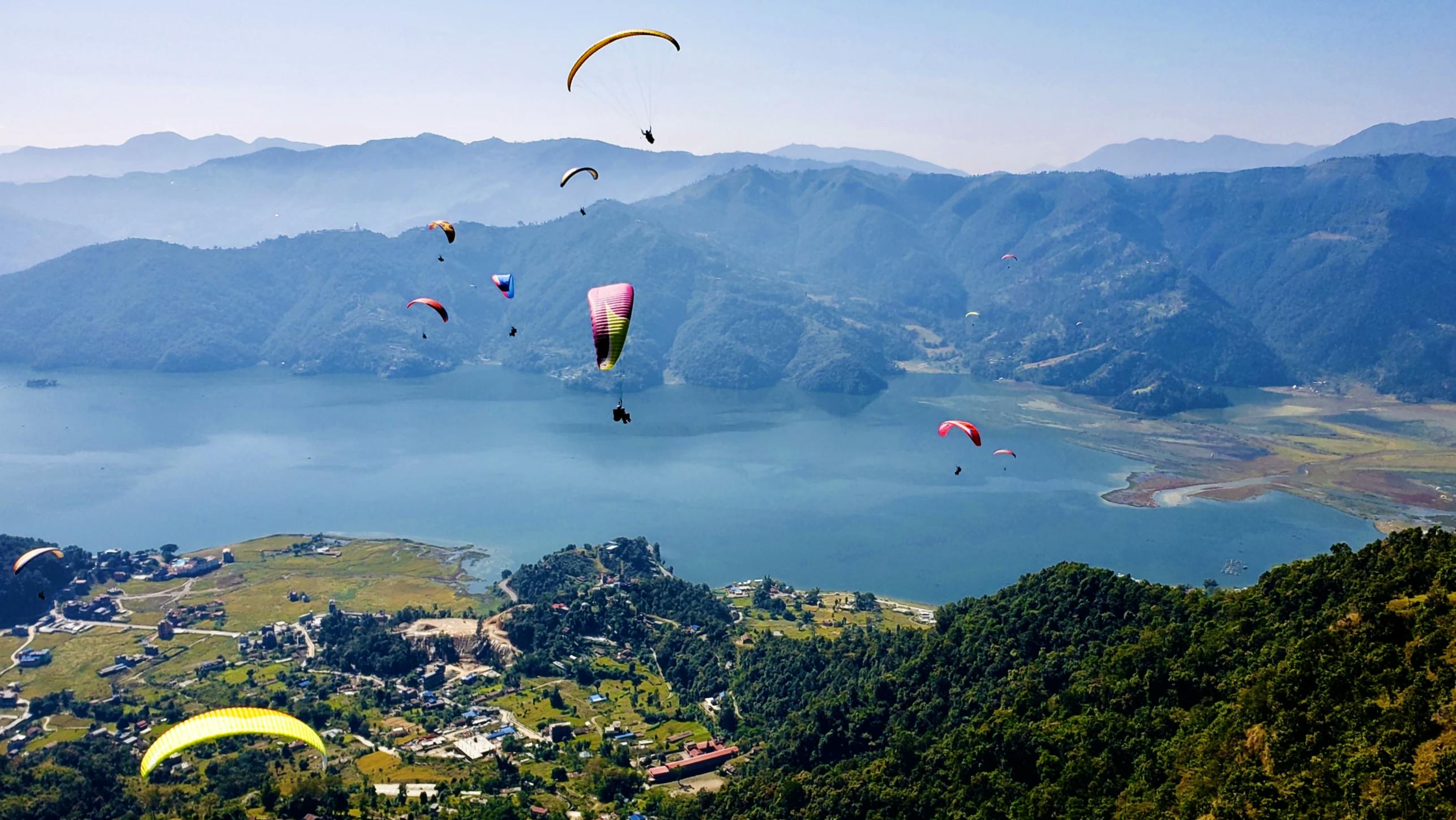 Open parachutes on top of beautiful landscape
