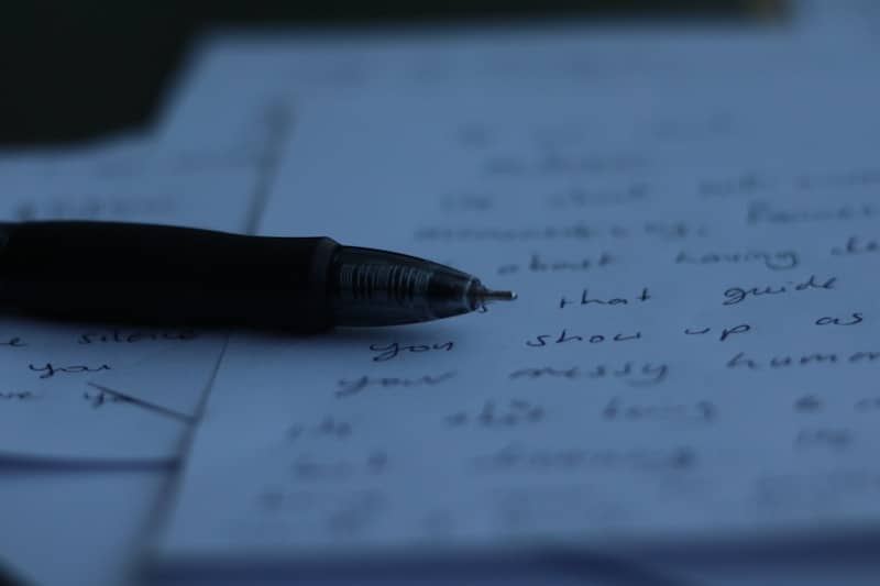A pen rests on handwritten notes