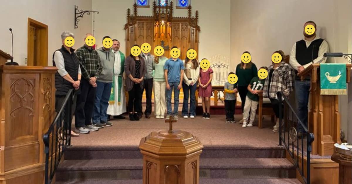 Group of people standing at the front of a church.