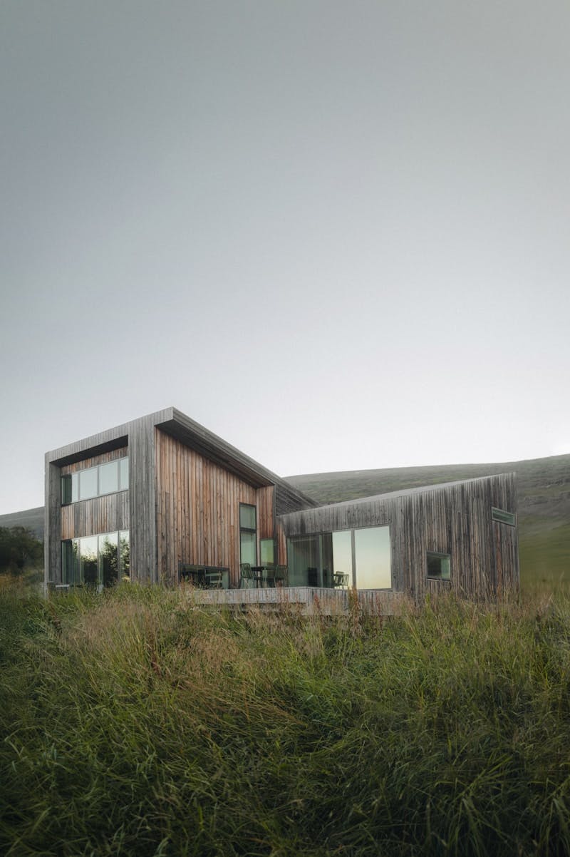 A house sitting on top of a lush green hillside