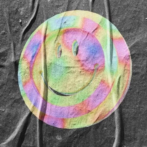 A colorful smiley face on a black background.