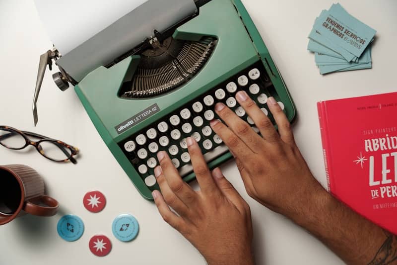 A person typing on an old fashioned typewriter