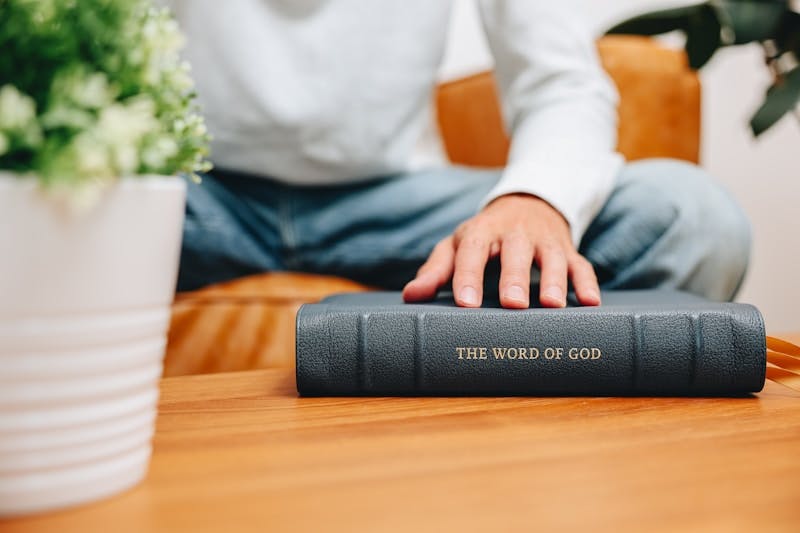 A man sitting at a table with a book in front of him