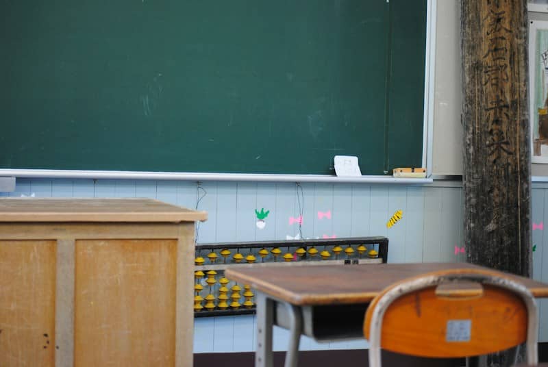 A classroom with a blackboard and desks