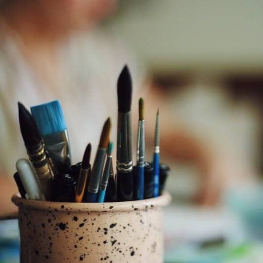 blue hair brushes in vase