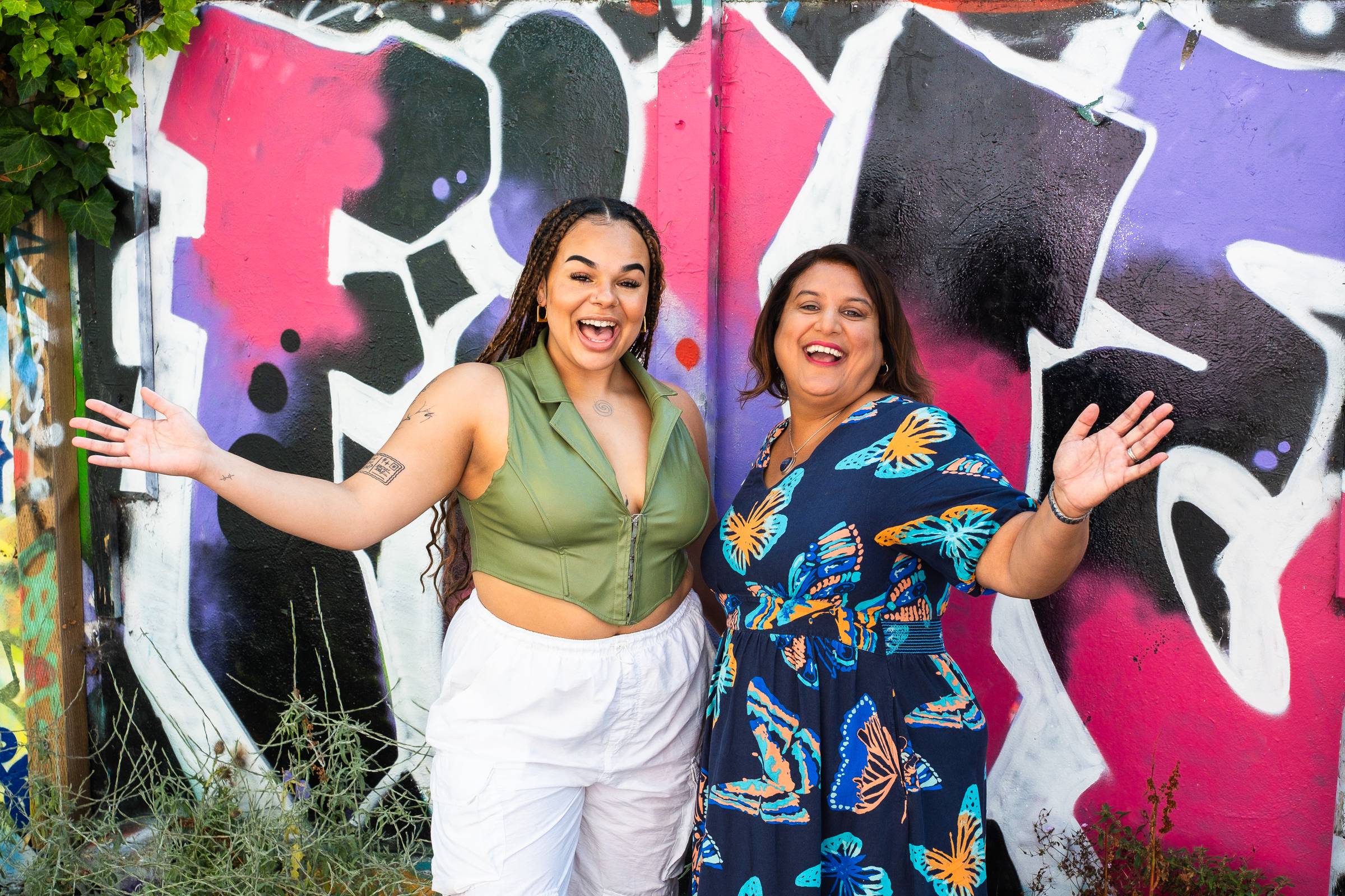 Mo and Kaia smiling against coloured background