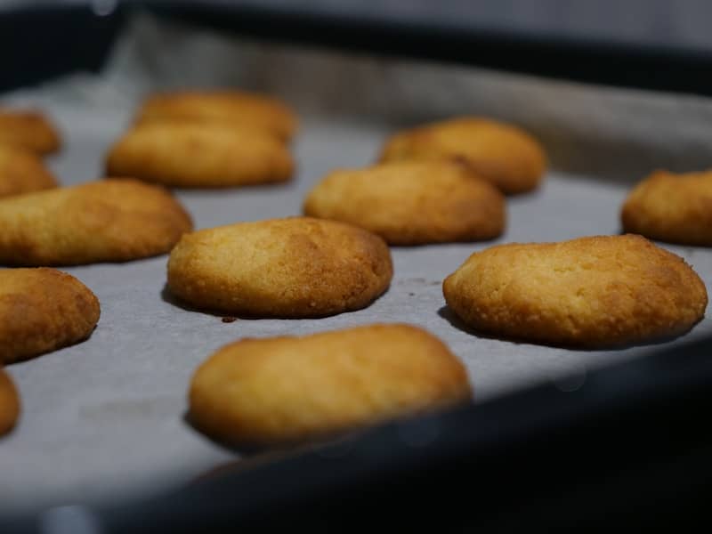 Golden brown cookies arranged on a baking sheet