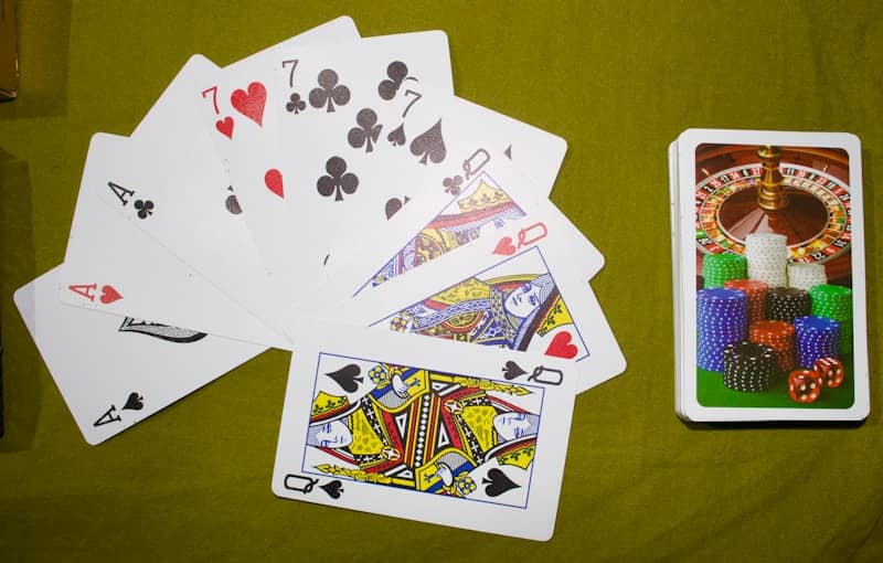 Playing cards and chips on a green felt table.