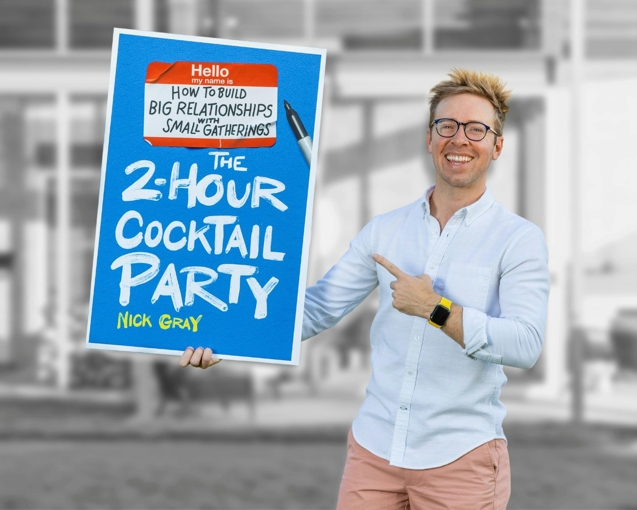 Nick holding a poster of The 2-Hour Cocktail Party book cover