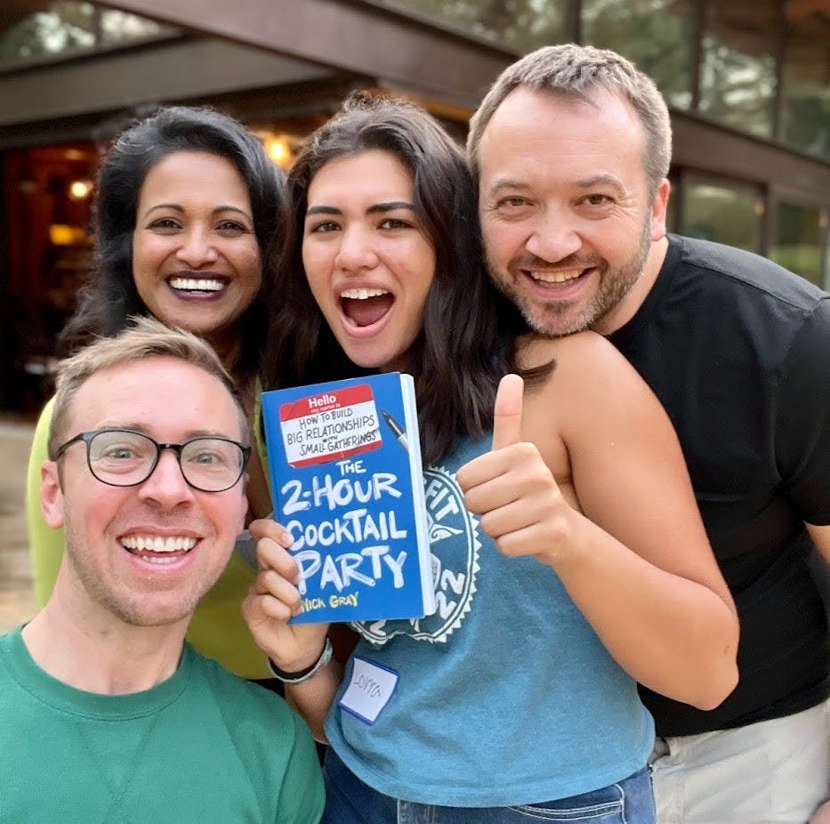 photo of 4 people smiling while showing the book called The 2-Hour Cocktail Party