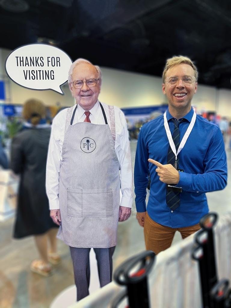 Me on the right standing with Warren Buffett on the left. He has a speech bubble that says "Thanks for visiting"
