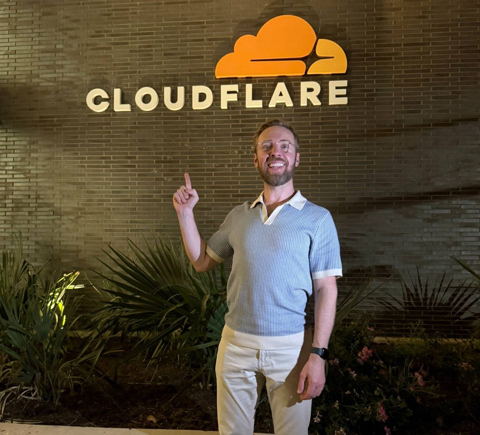 me standing under Cloudflare logo