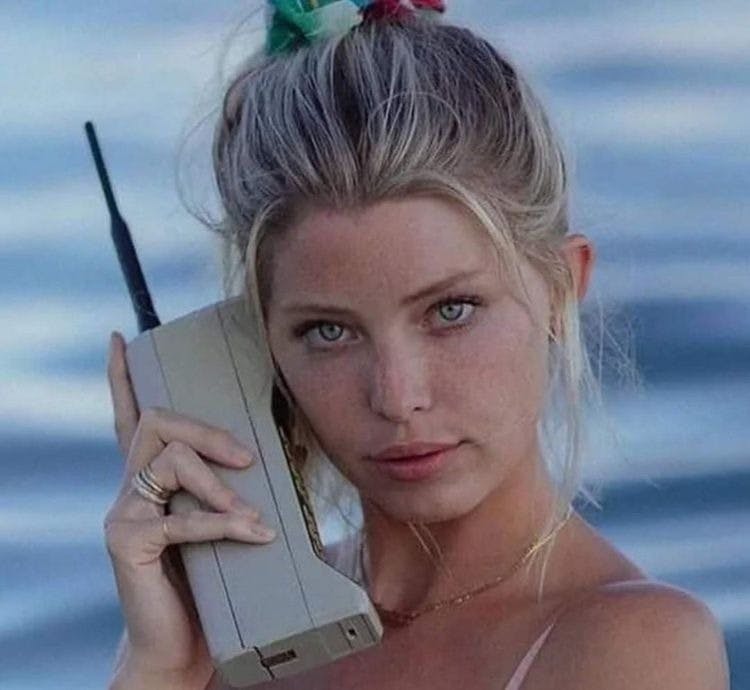 woman holding a Motorola DynaTAX 8000X 1984 phone