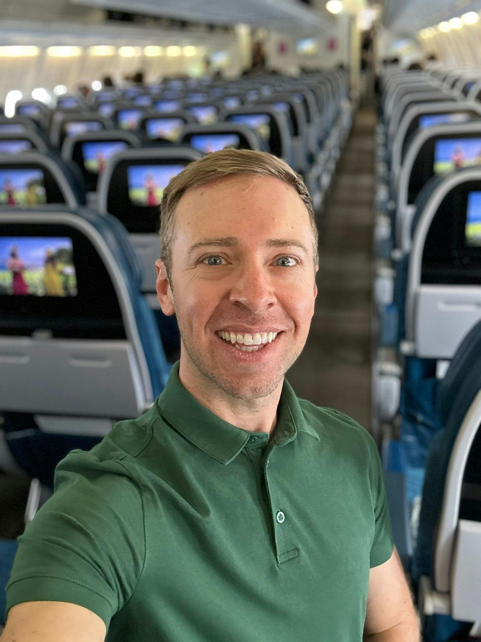 a selfie photo of Nick Gray inside a plane