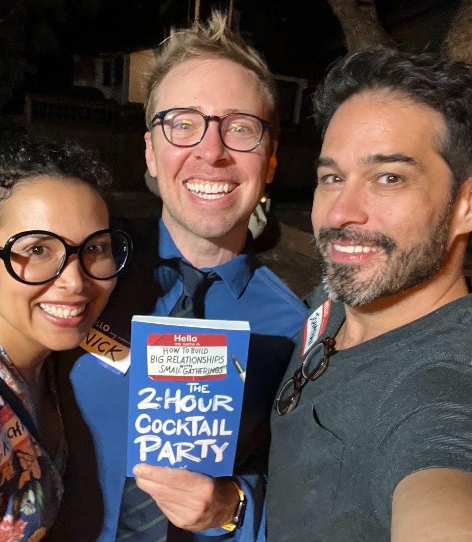 a couple with Nick Gray while holding his book The 2-Hour Cocktail Party