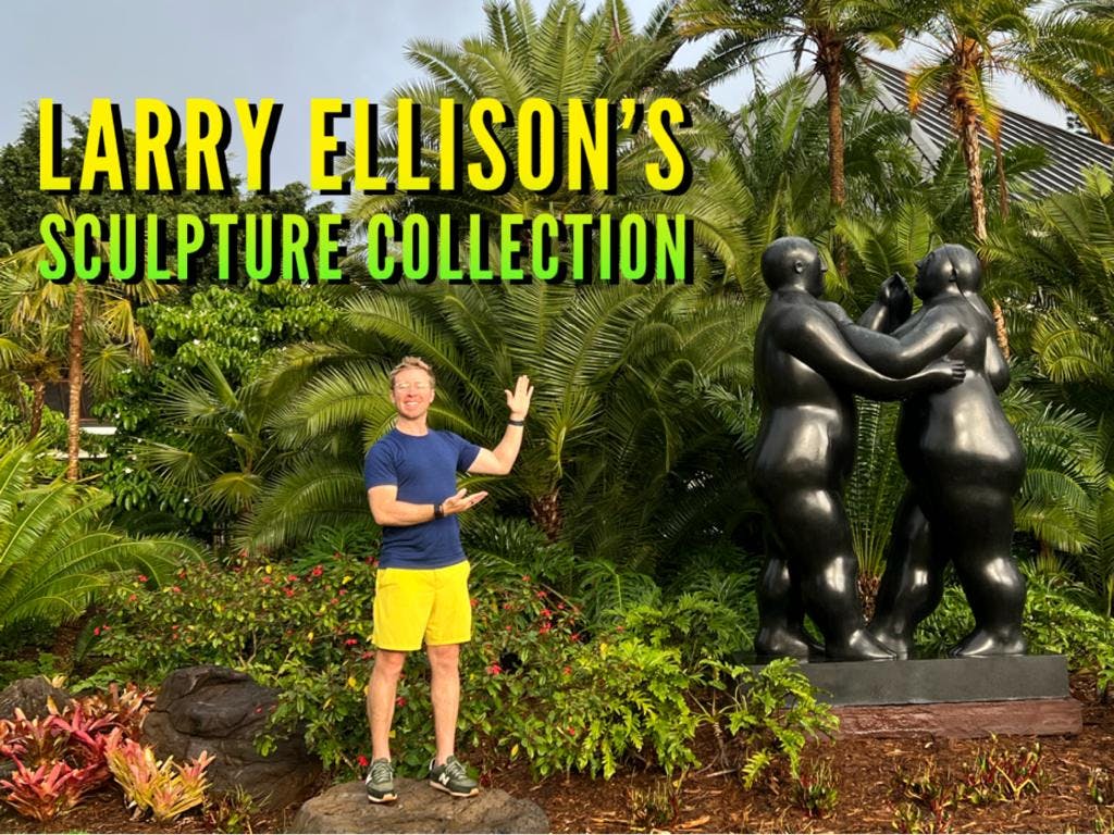 me wearing yellow shorts standing in front of some expensive sculptures