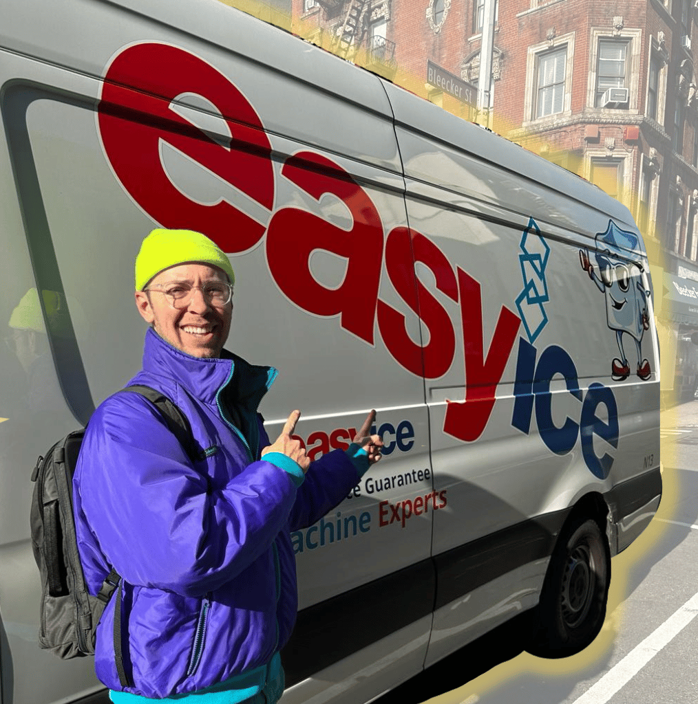 A man smiling and pointing to the Easy Ice truck in New York City
