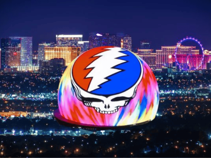 Image of Sphere in Las Vegas with the outside screens showing a tie-dyed stealie with the 13-point lightening bolt inside.