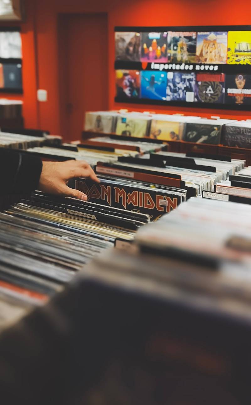 Hand browsing through iron maiden vinyl records