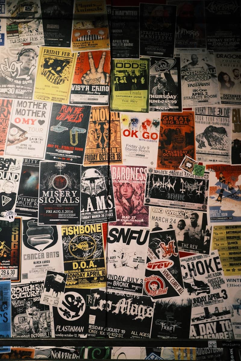 Collage of vintage concert posters and flyers on wall