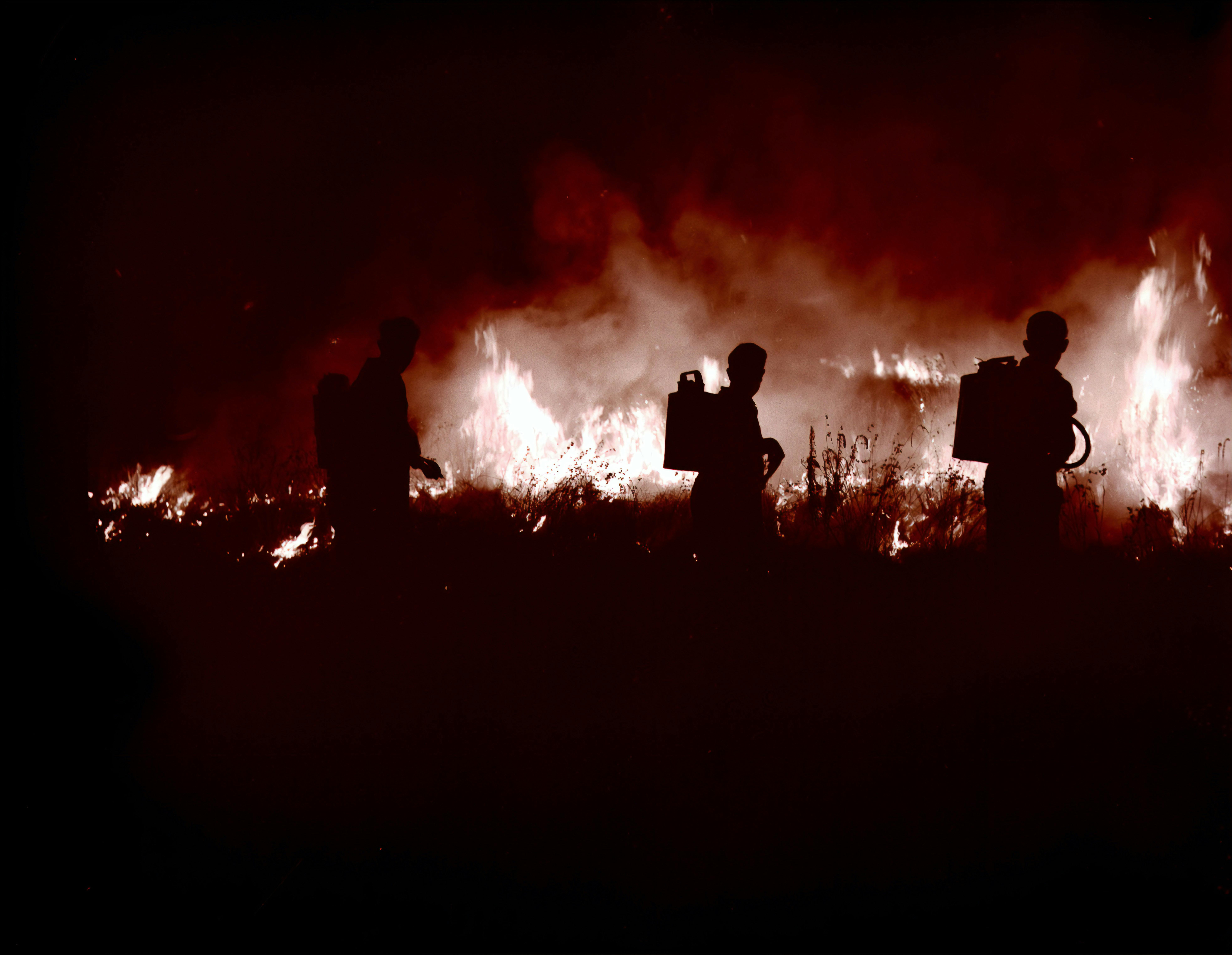Firefighters fighting a blaze in the dark