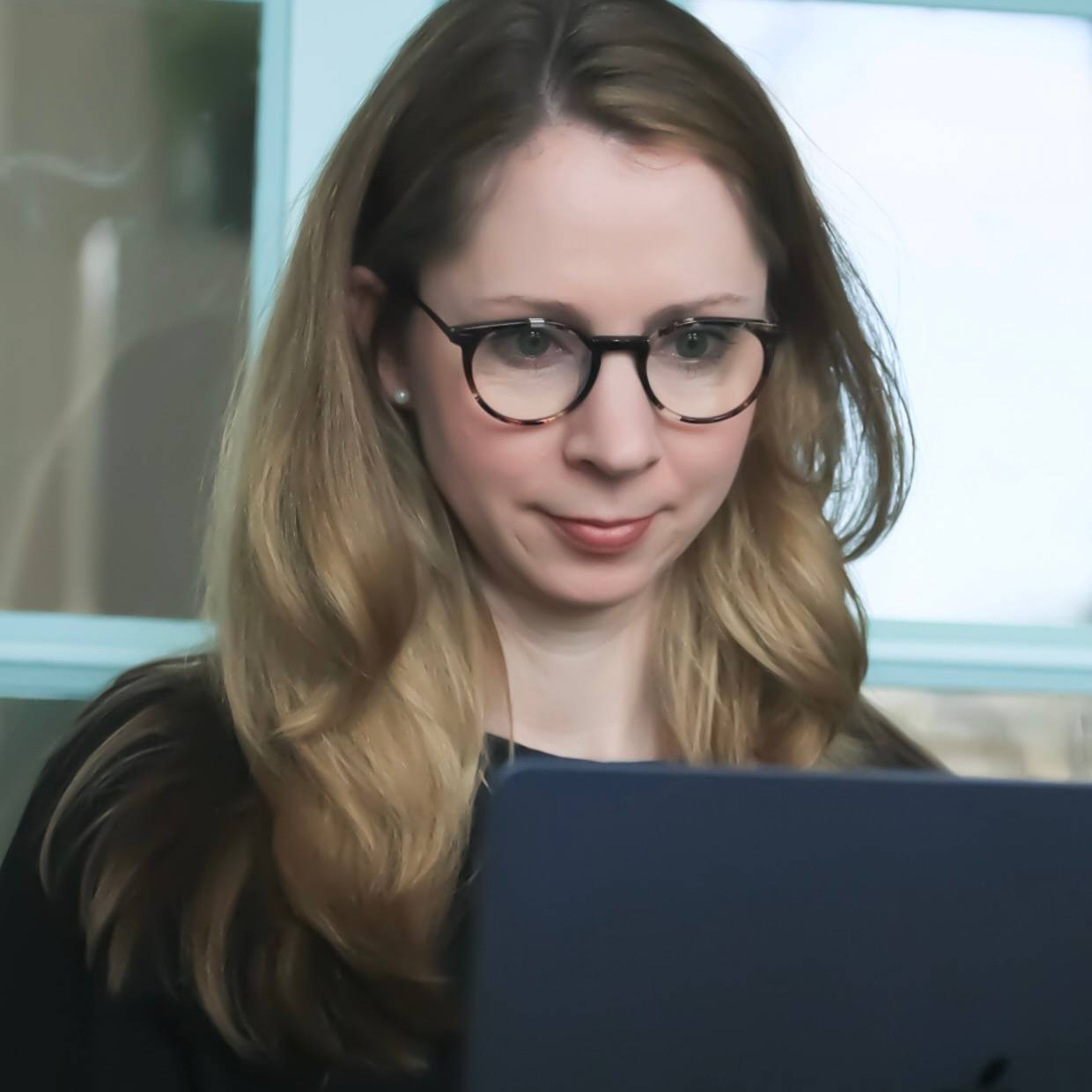 photo of the author, writing on her laptop