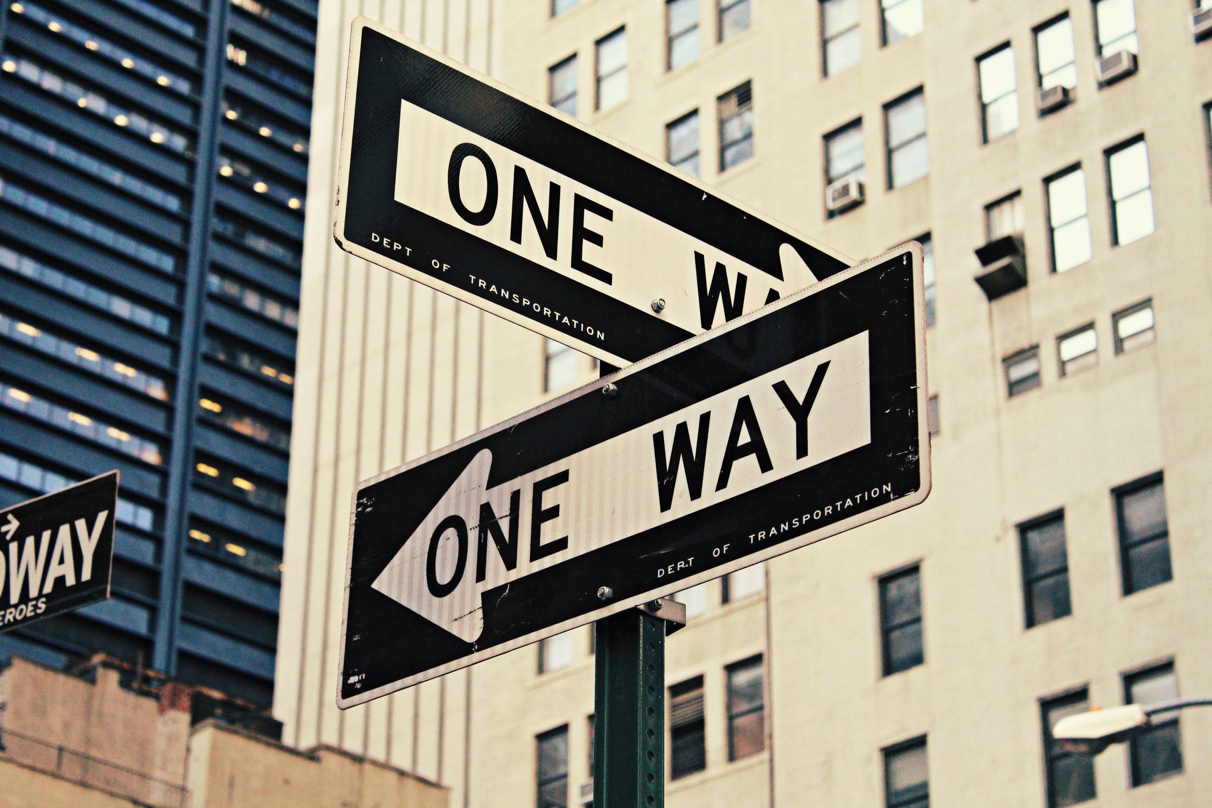 White and black one-way printed road signages