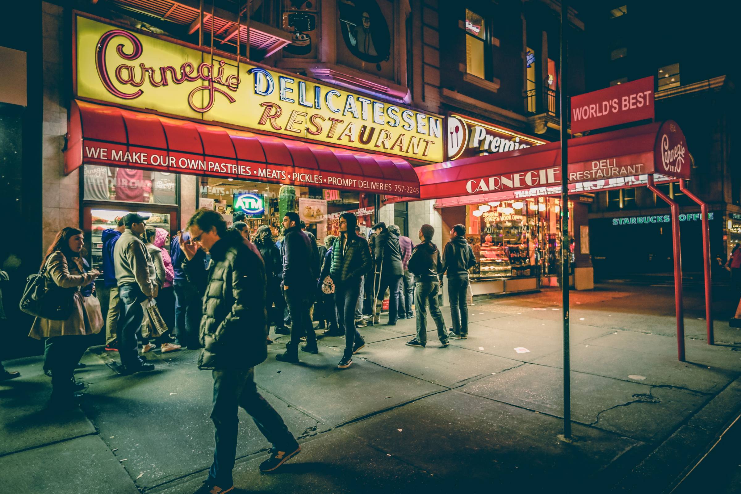 People waiting in front of the Carnegie Delicatessen Restaurant.