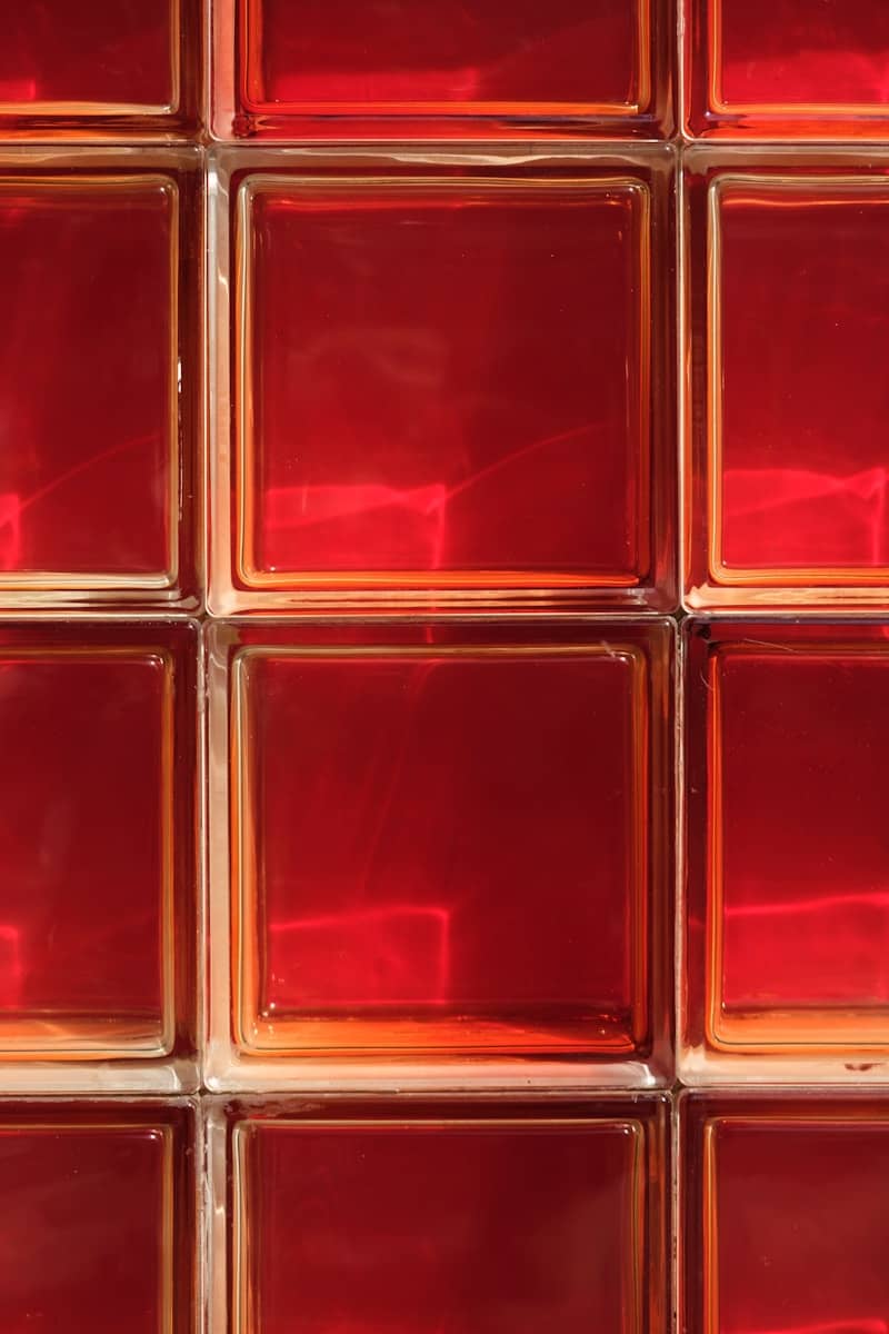 A close up of a red glass block wall