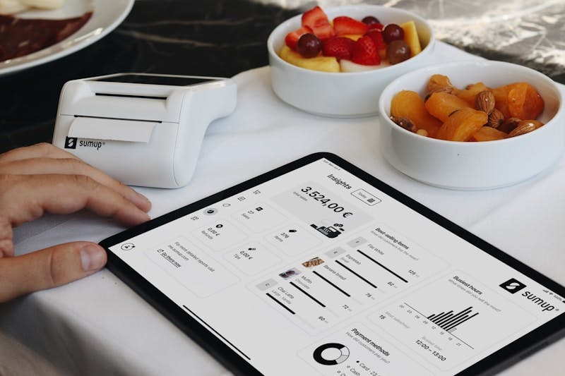 A person sitting at a table with a tablet