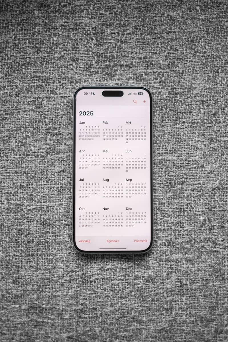 A white and black phone sitting on top of a gray surface