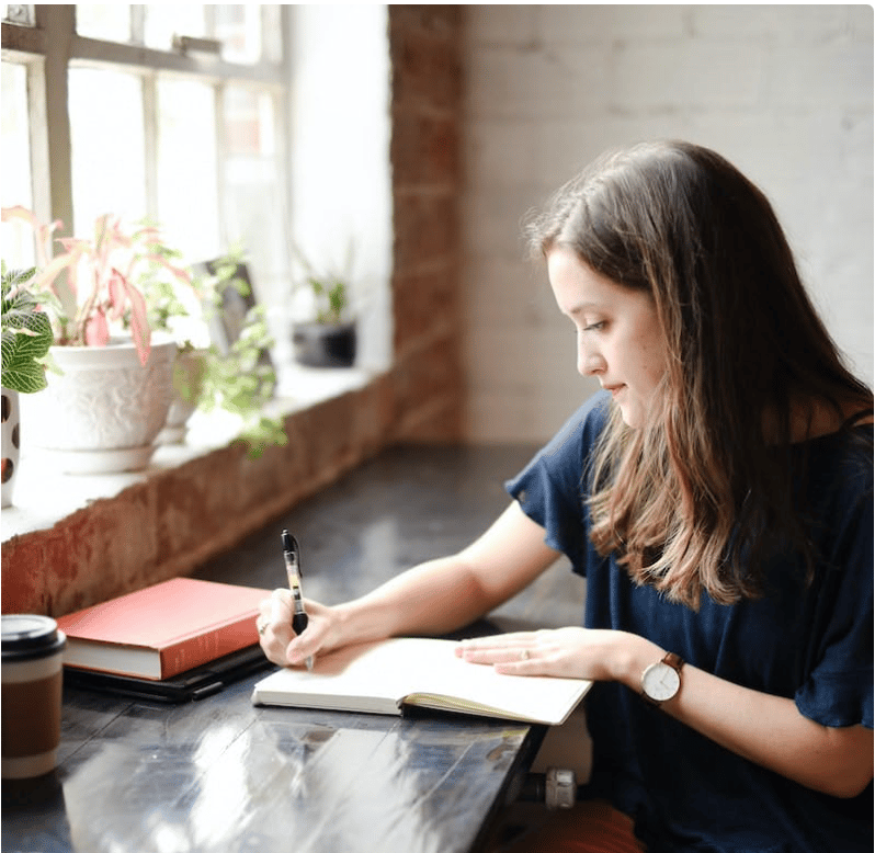 woman in blue cap and red sleeveless dress