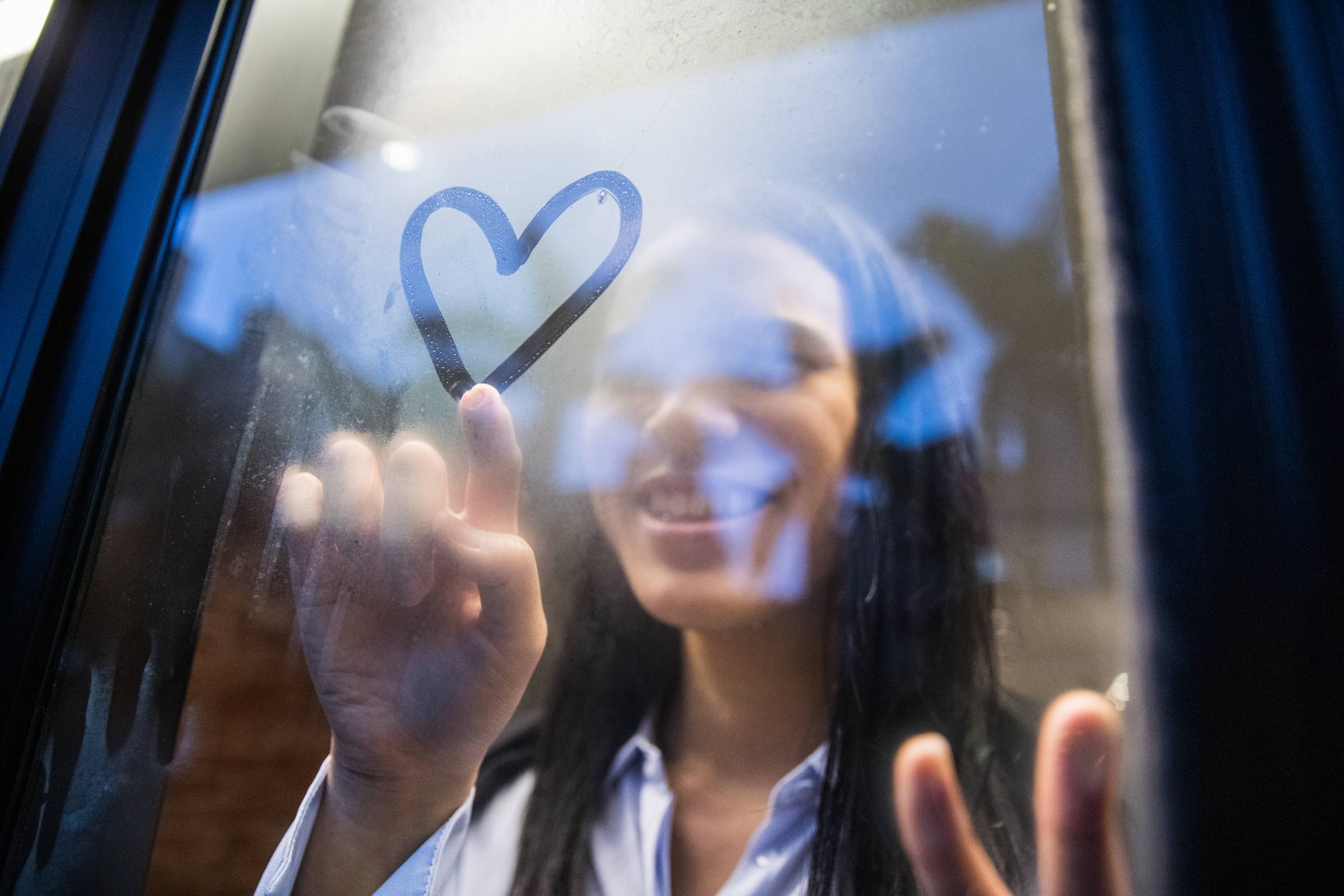 woman in blue cap and red sleeveless dress