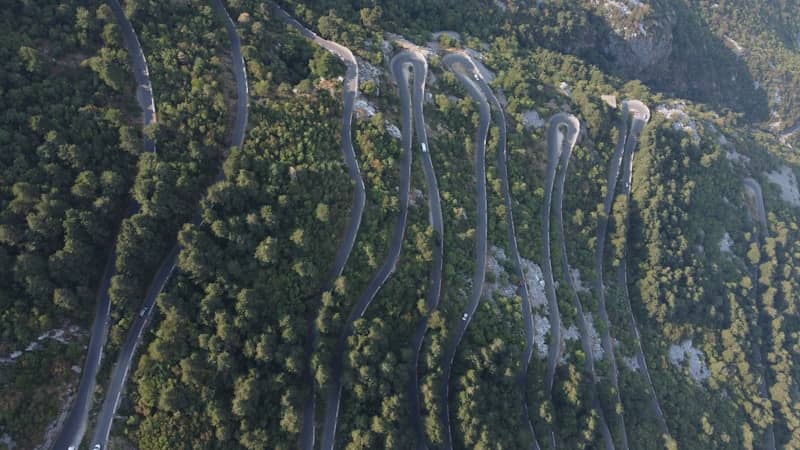 Winding mountain road through a dense forest