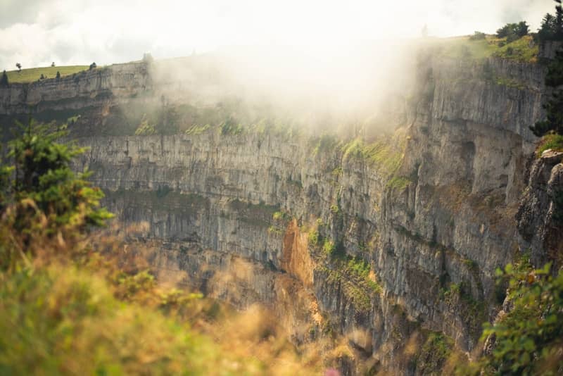 Cliffs enveloped in clouds and sunlight.