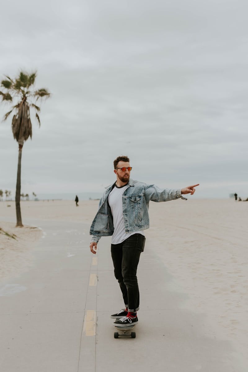 men's washed denim jacket riding a skateboard