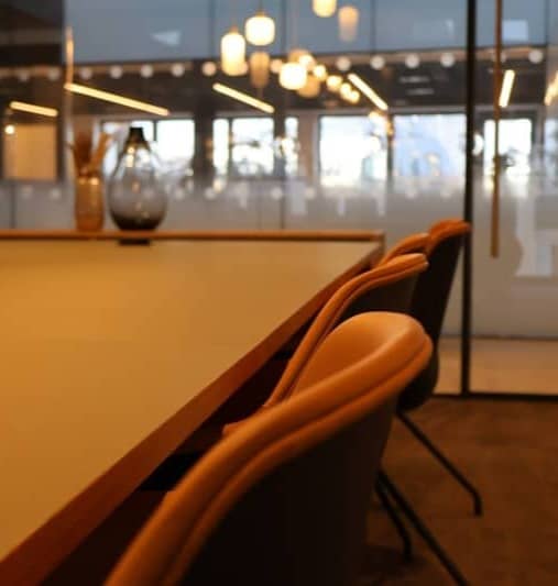 A conference room with a large table and chairs