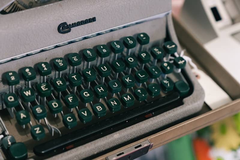 A vintage typewriter with green keys.