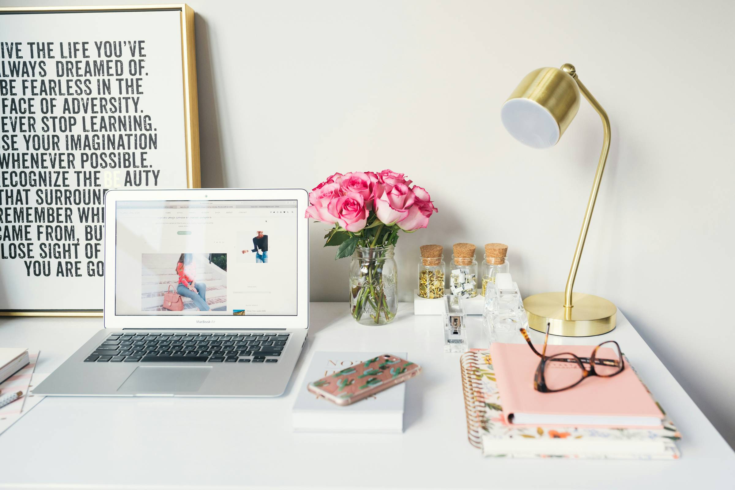 cozy desk feminine, with laptop journal flowers.