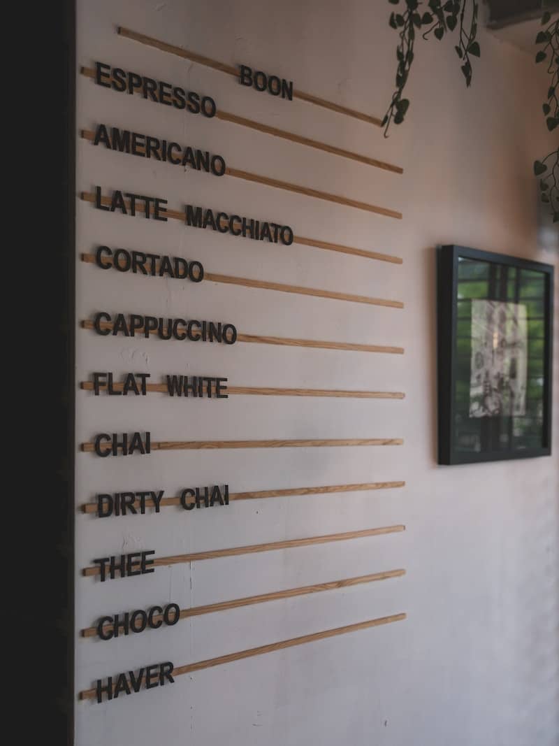 A cafe menu lists various coffee and tea drinks.