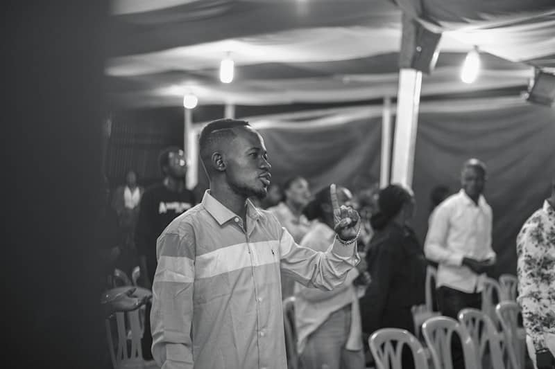 a man with a microphone in a room full of people