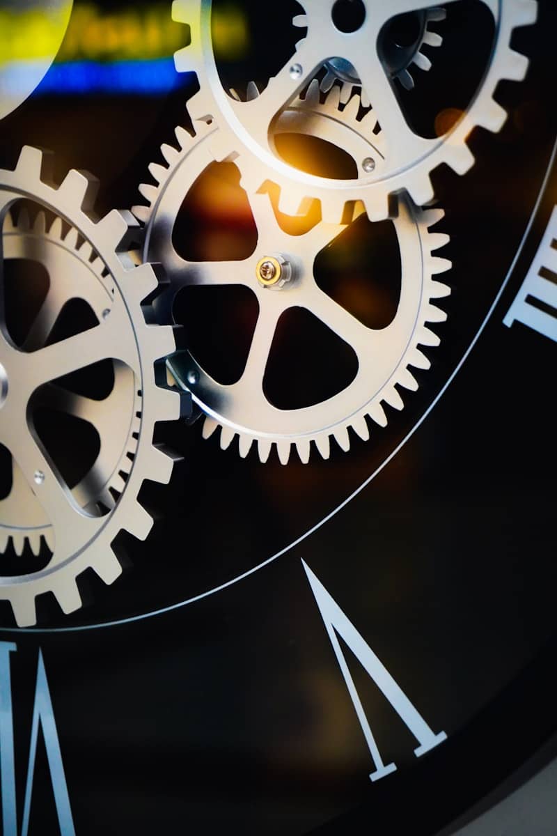 Close-up of intricate clockwork gears and roman numerals