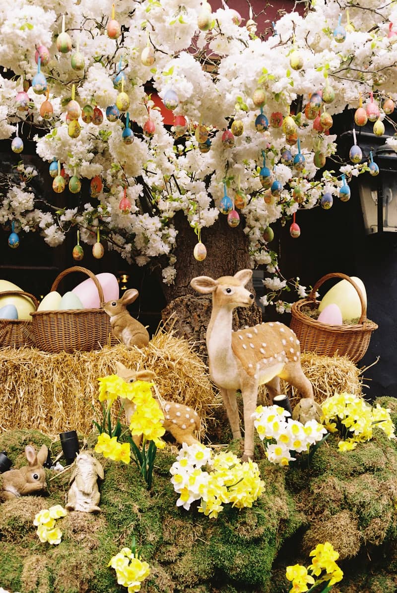 Easter display with decorated tree, bunnies, and deer.