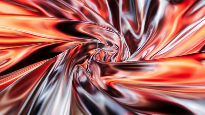 Swirling folds of metallic fabric in shades of orange, red, and silver