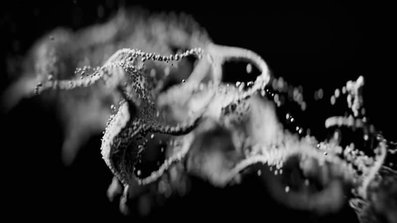 Bubbles and smoke swirling in dark liquid