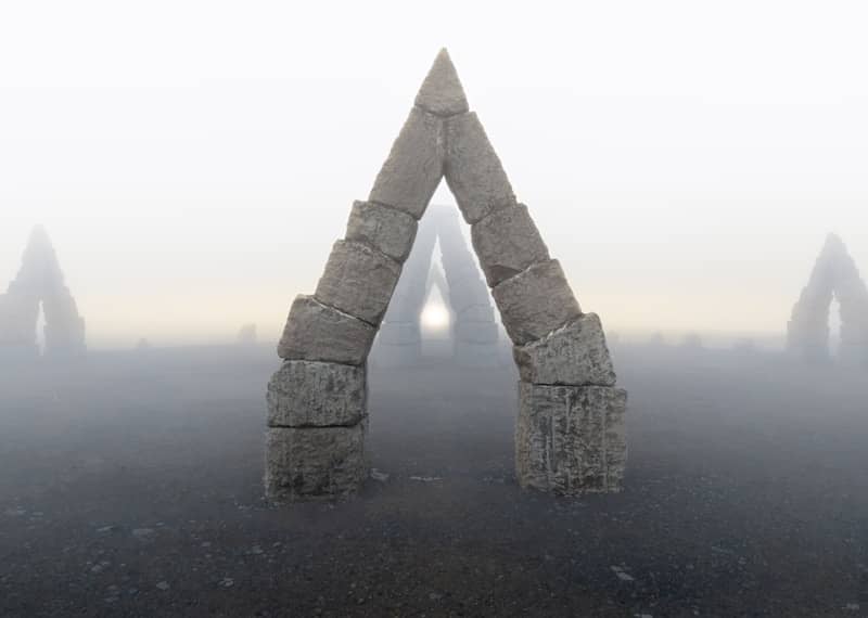 Arches emerge from the foggy landscape.
