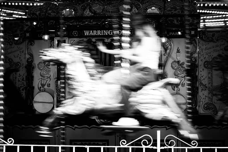 Blurred motion of a person on a carousel horse carousel