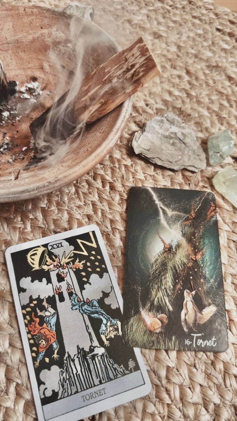Tarot cards with burning palo santo and crystals.