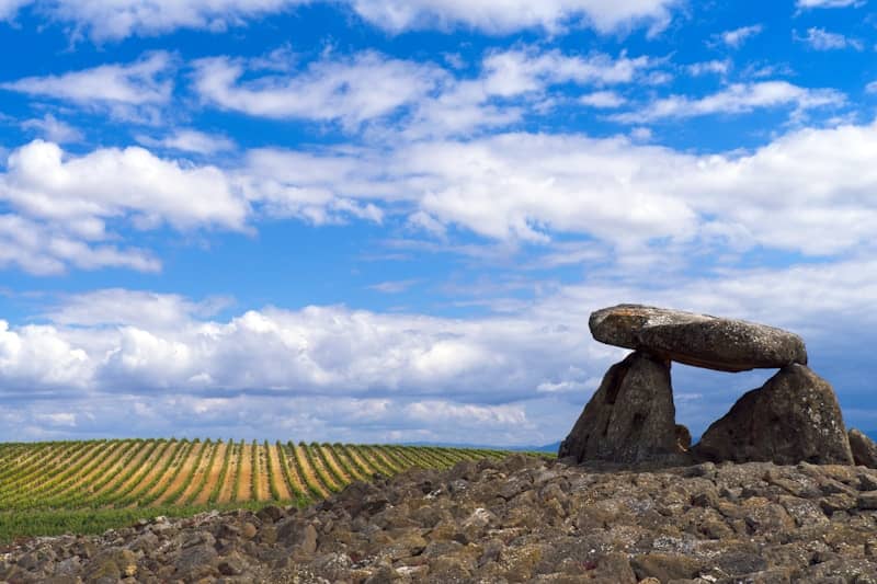 A rock formation in the middle of a field