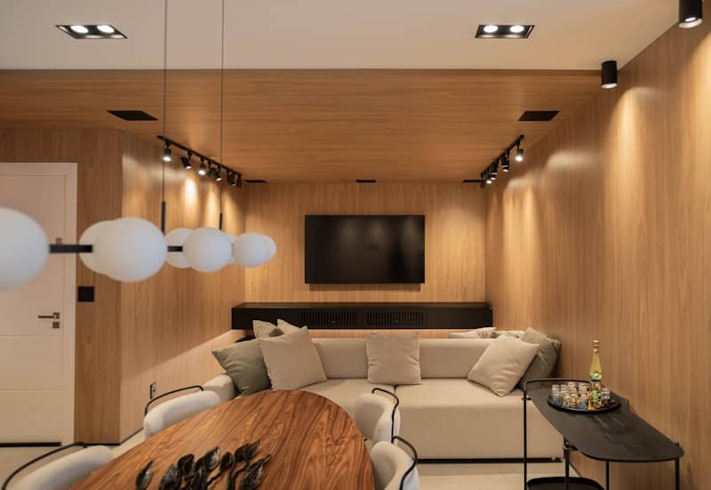 A modern living room with warm wood paneling.